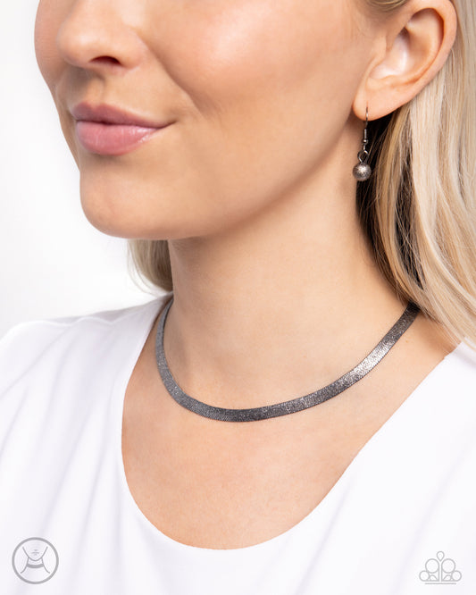 Simply Scintillating Black Choker Necklace - Paparazzi Accessories  Dusted with dainty shimmer, a curved collection of high-sheen gunmetal flat chain connects around the collar for a simply shimmery statement. Features an adjustable clasp closure.  Sold as one individual choker necklace. Includes one pair of matching earrings.  SKU: P2CH-BKXX-107XX