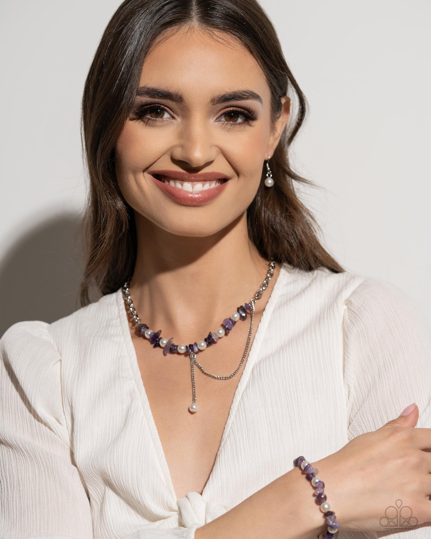 Robust Refinement Purple Stretch Bracelet - Paparazzi Accessories A collection of amethyst stones and white pearls are infused along an elastic stretchy band for a refined, tranquil statement. As the stone elements in this piece are natural, some color variation is normal. Sold as one individual bracelet. SKU: P9SE-PRXX-204WV Get The Complete Look! Necklace: "Nostalgically Noble - Purple" (Sold Separately)