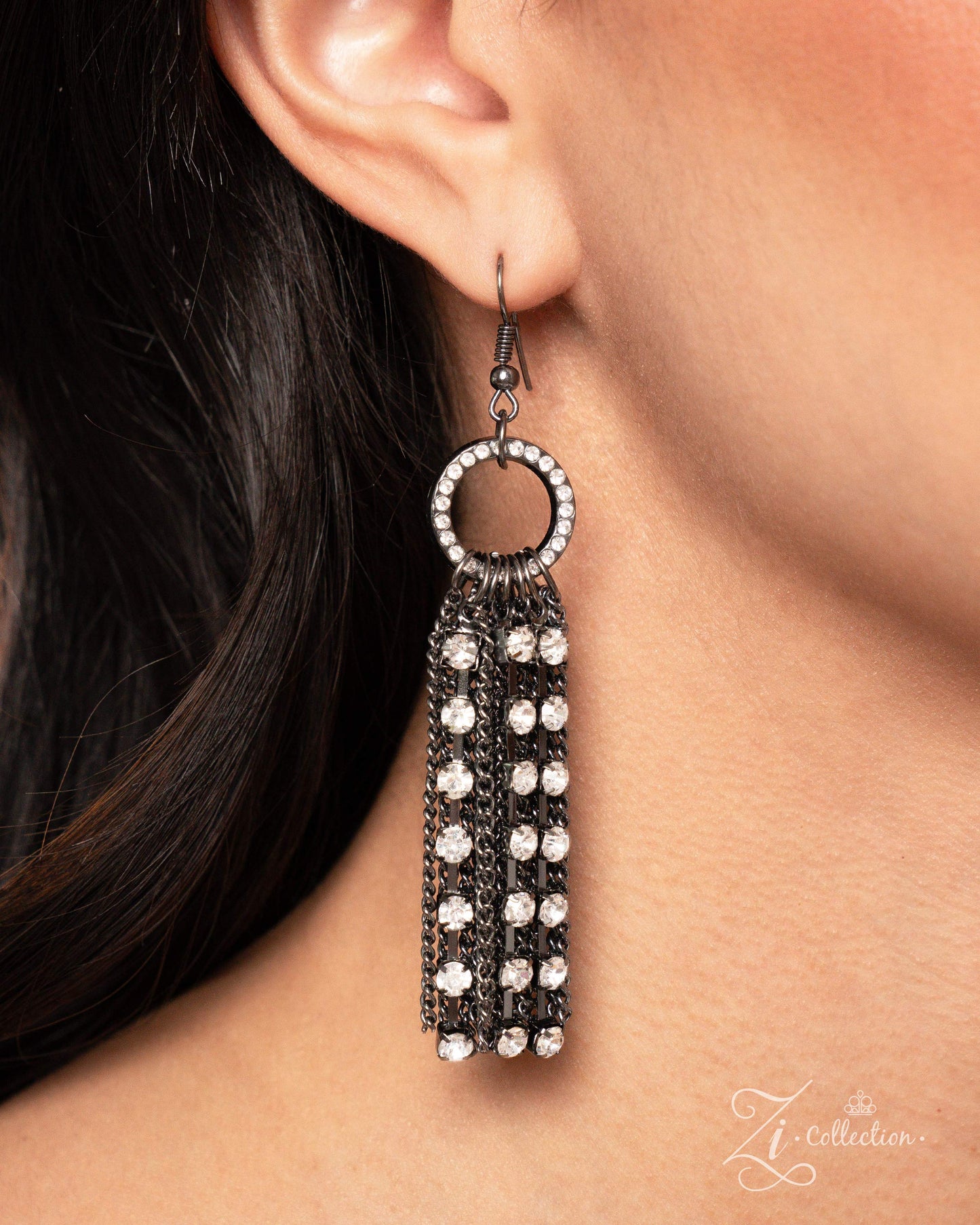 The Janet Gunmetal 2024 Zi Necklace - Paparazzi Accessories Item #Z2405 An entrancing collection of white rhinestones in square gunmetal fittings and strands of gunmetal classic chains delicately connect into grungy strands that dauntlessly drape across the chest. Interrupted by stacked white rhinestone-embellished gunmetal hoops, the swooping layers broaden in dimension and shimmer as they extend below the chest, swaying with every movement, creating an audaciously audible shimmer. Features an adjustable