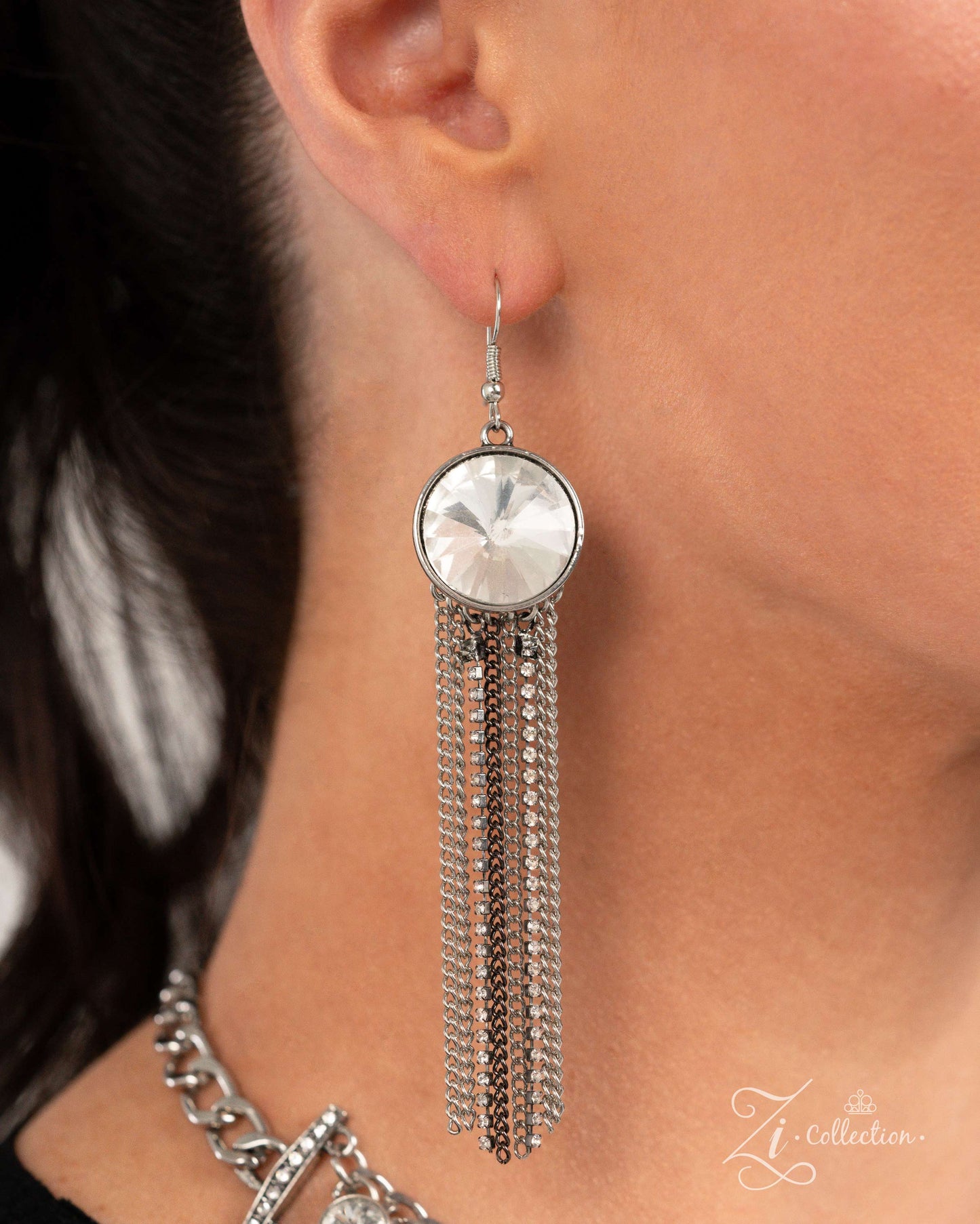 The Jennifer White Rhinestone 2024 Zi Necklace - Paparazzi Accessories Item #Z2406 Anchored between white rhinestone-embellished horizontal fittings, rows of glittery, white gems in varying sizes adorn the neckline between two silver curb chain strands, creating dazzling dimension and eye-catching elegance. Free-falling silver and gunmetal chains drape and collect below the extravagant row, creating a dramatic, sassy fringe for a show-stopping finish. Features an adjustable clasp closure. Sold as one ind