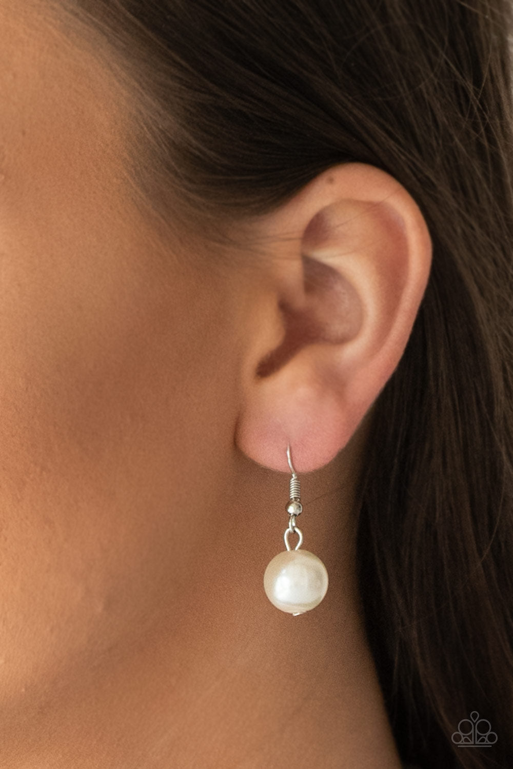 The More The Modest White Pearl Necklace - Paparazzi Accessories Infused with dainty silver accents, classic white pearls layer below the collar in a timeless fashion. Features an adjustable clasp closure. All Paparazzi Accessories are lead free and nickel free! Sold as one individual necklace. Includes one pair of matching earrings.