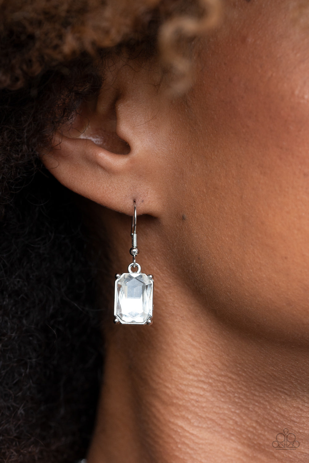 Deep Freeze Diva White Necklace - Paparazzi Accessories Featuring regal emerald style cuts, an oversized collection of white rhinestones dramatically link below the collar for an icy finish. Features an adjustable clasp closure. All Paparazzi Accessories are lead free and nickel free! Sold as one individual necklace. Includes one pair of matching earrings.