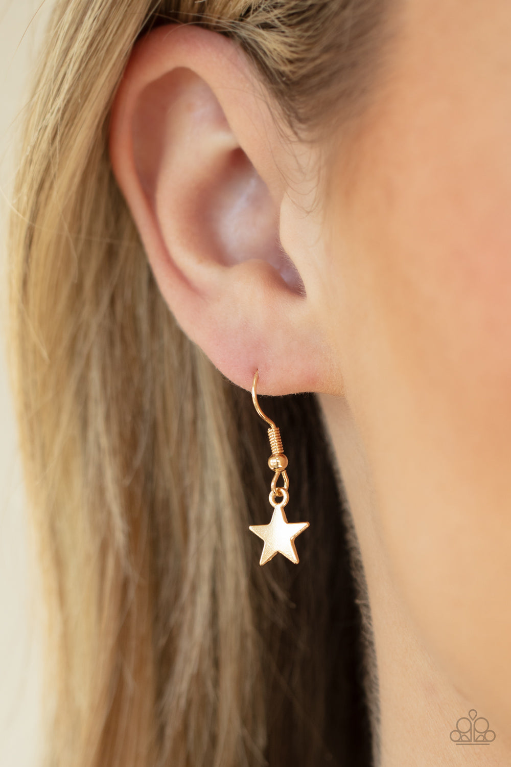 Stellar Stardom Gold Necklace - Paparazzi Accessories A mismatched collection of shiny gold stars cascade from a dainty gold chain, creating a stellar fringe below the collar. Features an adjustable clasp closure. All Paparazzi Accessories are lead free and nickel free! Sold as one individual necklace. Includes one pair of matching earrings.