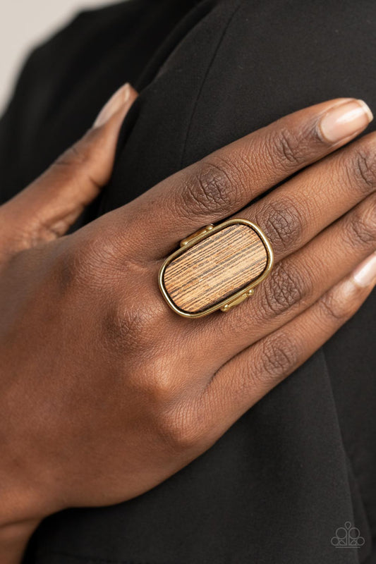 Reclaimed Refinement Gold Ring - Paparazzi Accessories  Encased in a sleek gold frame, a rustic piece of wood sits atop the finger for an unexpected refinement. Features a stretchy band for a flexible fit.  All Paparazzi Accessories are lead free and nickel free!  Sold as one individual ring.