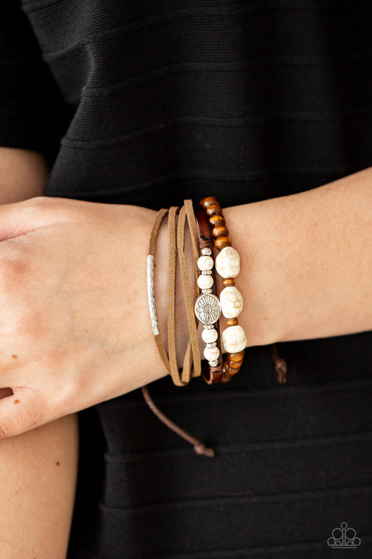 Act Natural White Urban Bracelet - Paparazzi Accessories  Featuring natural white stone and silver accents, a collection of leather strands and wooden beads encircle the wrist in a subtle Southwestern fashion. Features an adjustable sliding knot closure.  Sold as one individual bracelet.