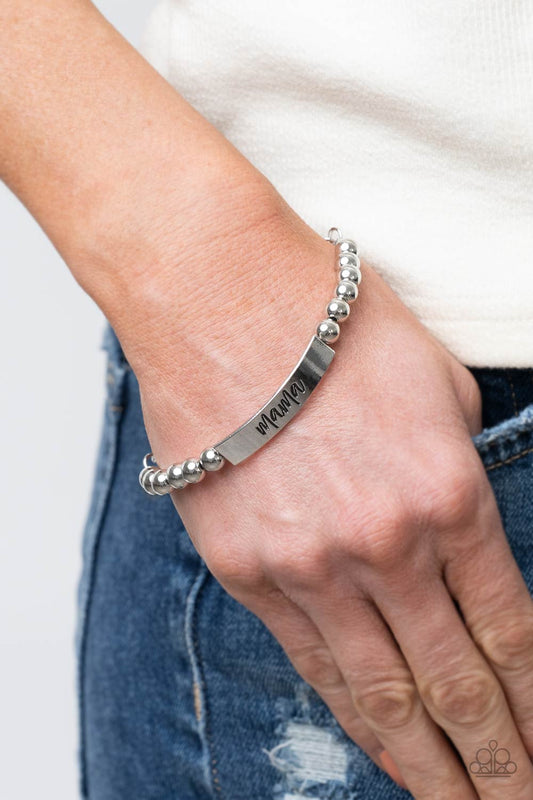 Mom Squad Silver Bracelet - Paparazzi Accessories  Stamped in the word, "Mama," a curved silver plate attaches to strands of silver beads threaded along invisible wire around the wrist, creating a sentimental centerpiece. Features an adjustable clasp closure.  Sold as one individual bracelet.