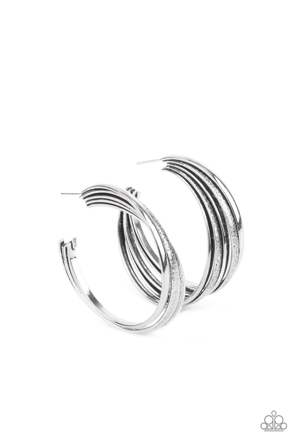 In Sync Silver Hoop Earring - Paparazzi Accessories Alternating rings of textured and shiny silver fuse together creating a curvy ribbon of rustic drama as they wrap around behind the ear. Earring attaches to a standard post fitting. Hoop measures approximately 2" in diameter. All Paparazzi Accessories are lead free and nickel free! Sold as one pair of hoop earrings.
