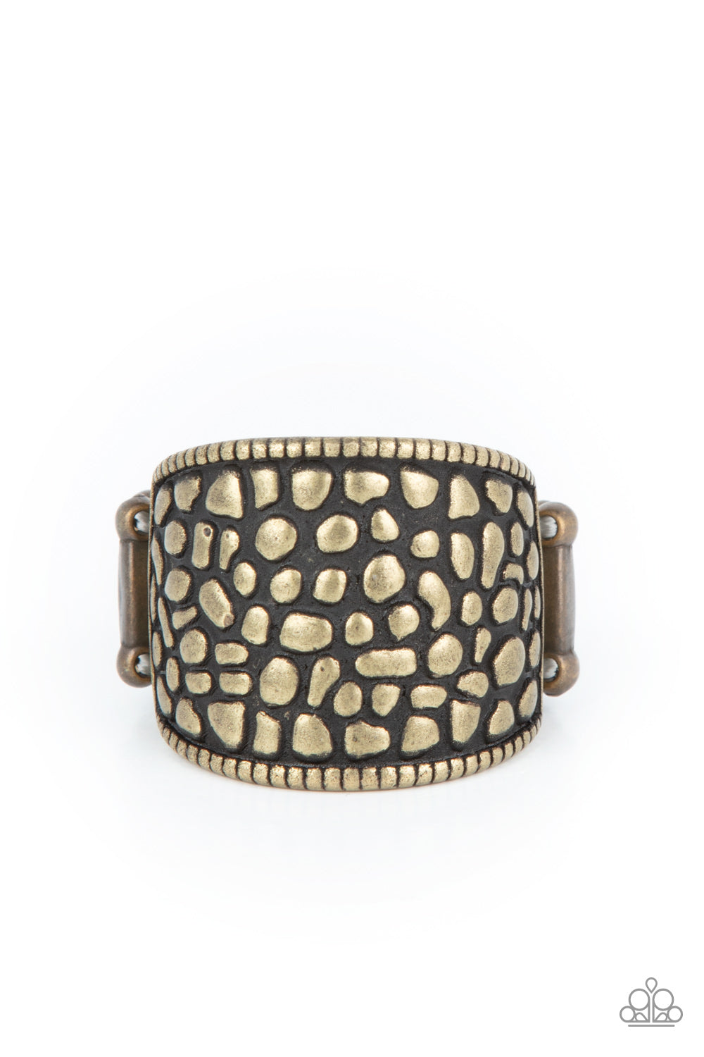 Dotted Decorum - Brass Item #P4BA-BRXX-025XX Brimming from edge to edge with a studded texture reminiscent of cobblestone, a wide brass band is bordered in dainty studs resulting in a free-spirited fashion atop the finger. Features a stretchy band for a flexible fit. Sold as one individual ring.