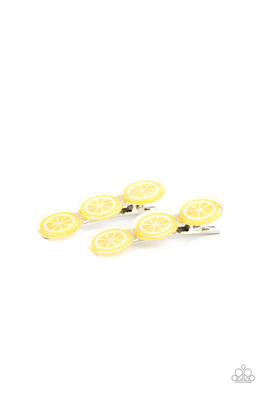 Charismatically Citrus Yellow Hair Clip - Paparazzi Accessories  Sprinkled in sparkle, a zesty trio of lemon frames coalesce into a citrusy pair of hair clips. Features standard hair clips on the back.  Sold as one pair of hair clips.