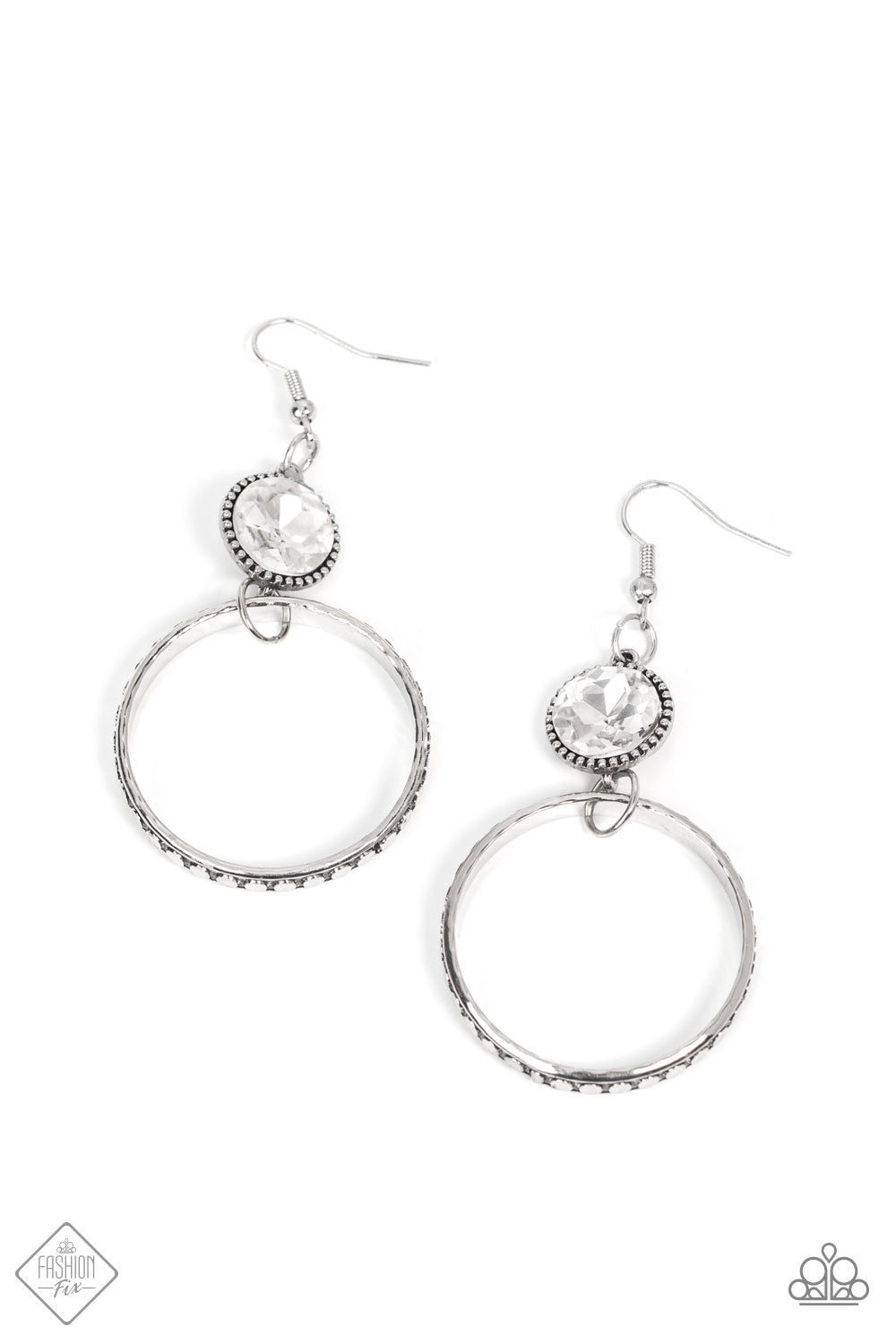 Standalone Sparkle White Earring - Paparazzi Accessories The outer edge of a silver ring is stamped with a flattened dot motif as it swings below a dramatic white rhinestone that sparkles inside a daintily dotted antiqued silver frame, creating an upscale, edgy modern lure. Earring attaches to a standard fishhook fitting. Sold as one pair of earrings.