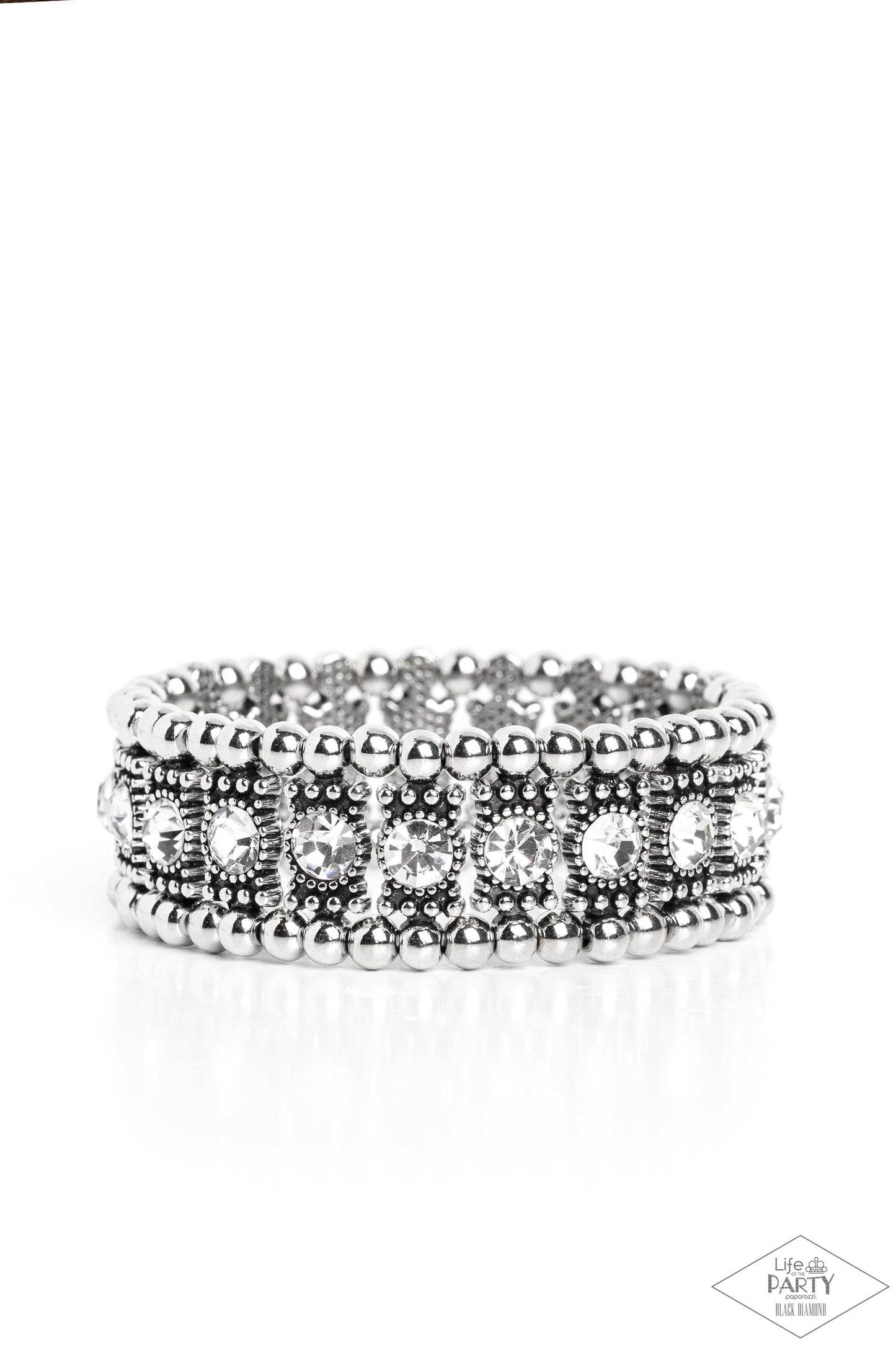 Ritzy Reboot White Bracelet - Paparazzi Accessories A dazzling row of sparkling white rhinestones set in dotted frames is bordered by a row of dainty antiqued silver studs. Shiny round silver beads form the outermost border of this luxuriously layered design, which is threaded along stretchy bands for an upscale edgy look. P9ED-WTXX-034EE This Black Diamond Encore is back in the spotlight at the request of our 2022 Life of the Party member with Black Diamond Access, Tracey G.