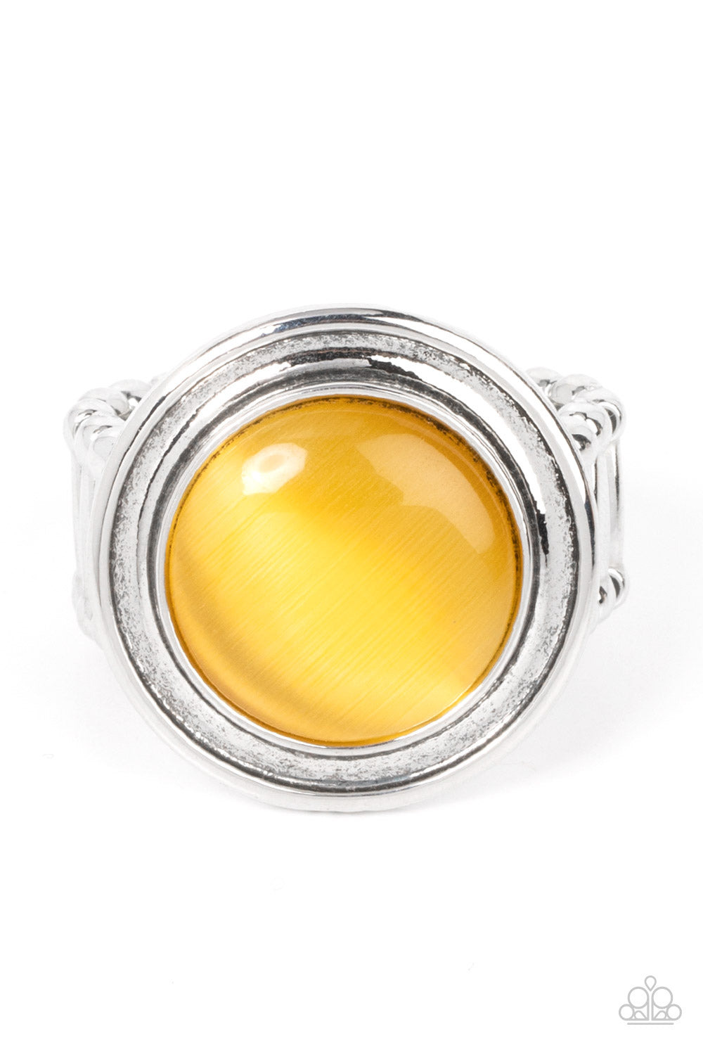 Laguna Luminosity Yellow Ring - Paparazzi Accessories A yellow cat's eye stone is encircled in rippling silver frames, pooling into an ethereal pop of color atop the finger. Features a stretchy band for a flexible fit. Sold as one individual ring.