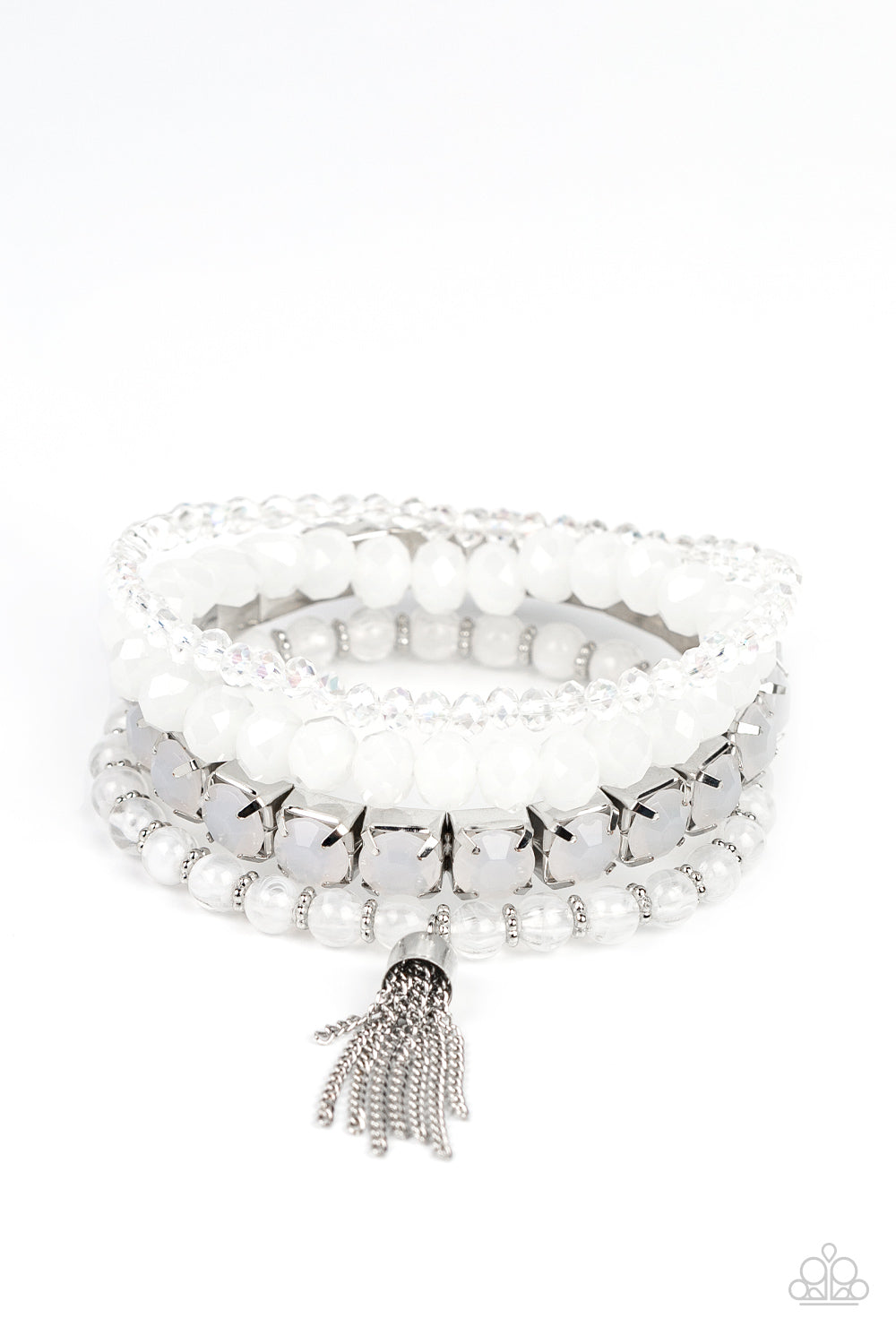 Day Trip Trinket White Bracelet - Paparazzi Accessories Pinched in silver fittings, a stretchy band of dewy white beads joins mismatched strands of cloudy and glassy white crystal-like and stretchy bracelets around the wrist. A single silver chain tassel dances from the crystalline compilation for a final flirty finesse. Sold as one set of four bracelets.