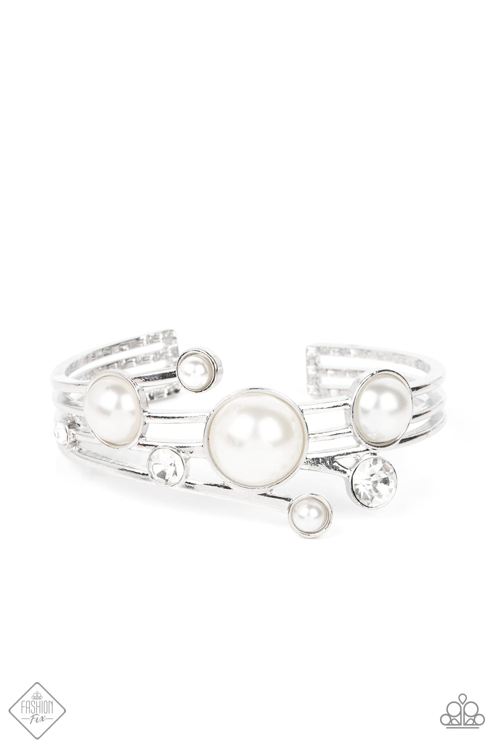 Total SAIL-Out White Cuff Bracelet - Paparazzi Accessories Luxuriously oversized pearl beads, encased in silver frames, mingle with brilliant white rhinestones, as they drift across silver bands that flare out on either side before wrapping into an airy cuff around the wrist. Sold as one individual bracelet.