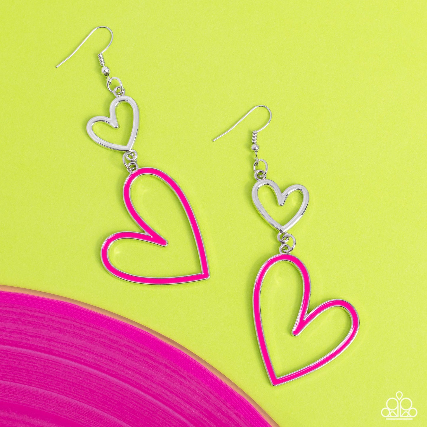 Pristine Pizzazz Pink Heart Earring - Paparazzi Accessories Dangling from an abstract silver heart frame, another heart frame, this time an oversized one, features a border of Pink Peacock paint, creating an attention-grabbing romantic statement below the ear. Earring attaches to a standard fishhook fitting. Sold as one pair of earrings. P5WH-PKXX-275XX
