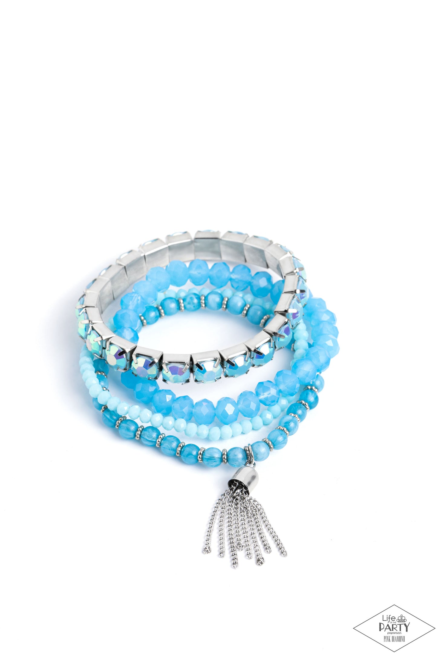 Day Trip Trinket Blue Stretch Bracelet - Paparazzi Accessories Pinched in silver fittings, a band of UV shimmery Waterspout beads joins mismatched strands of smoky, glassy, and faceted blue beads creating four stretchy bracelets around the wrist. A single silver chain tassel dances from the crystalline compilation for a final flirty finesse. Sold as one set of four bracelets. P9WH-BLXX-283XX