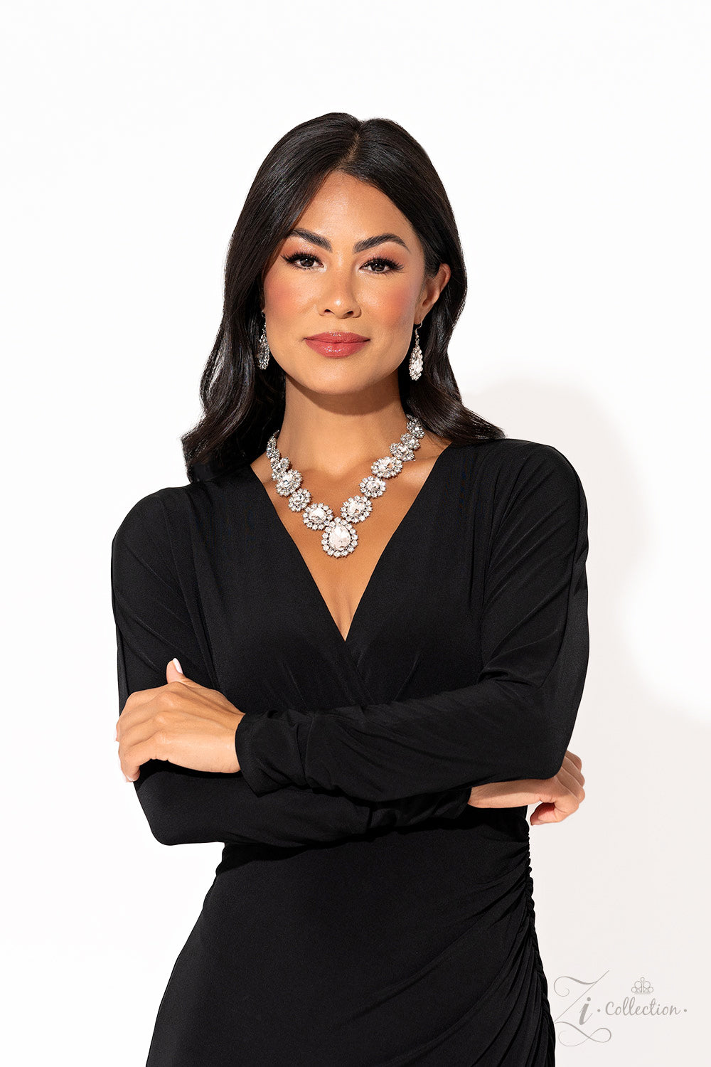 Everlasting White Rhinestone 2023 Zi Collection Necklace - Paparazzi Accessories Brilliant white rhinestones, in both round and oval cuts, link around the neck in a stunning display. Each dramatically faceted gem is encircled by tiny white rhinestones set in pronged fittings, bringing a vintage charisma to the design. The floral-inspired frames gradually increase in size as they lead towards the center, where a teardrop-shaped gem drips into the spotlight. Features an adjustable clasp closure.