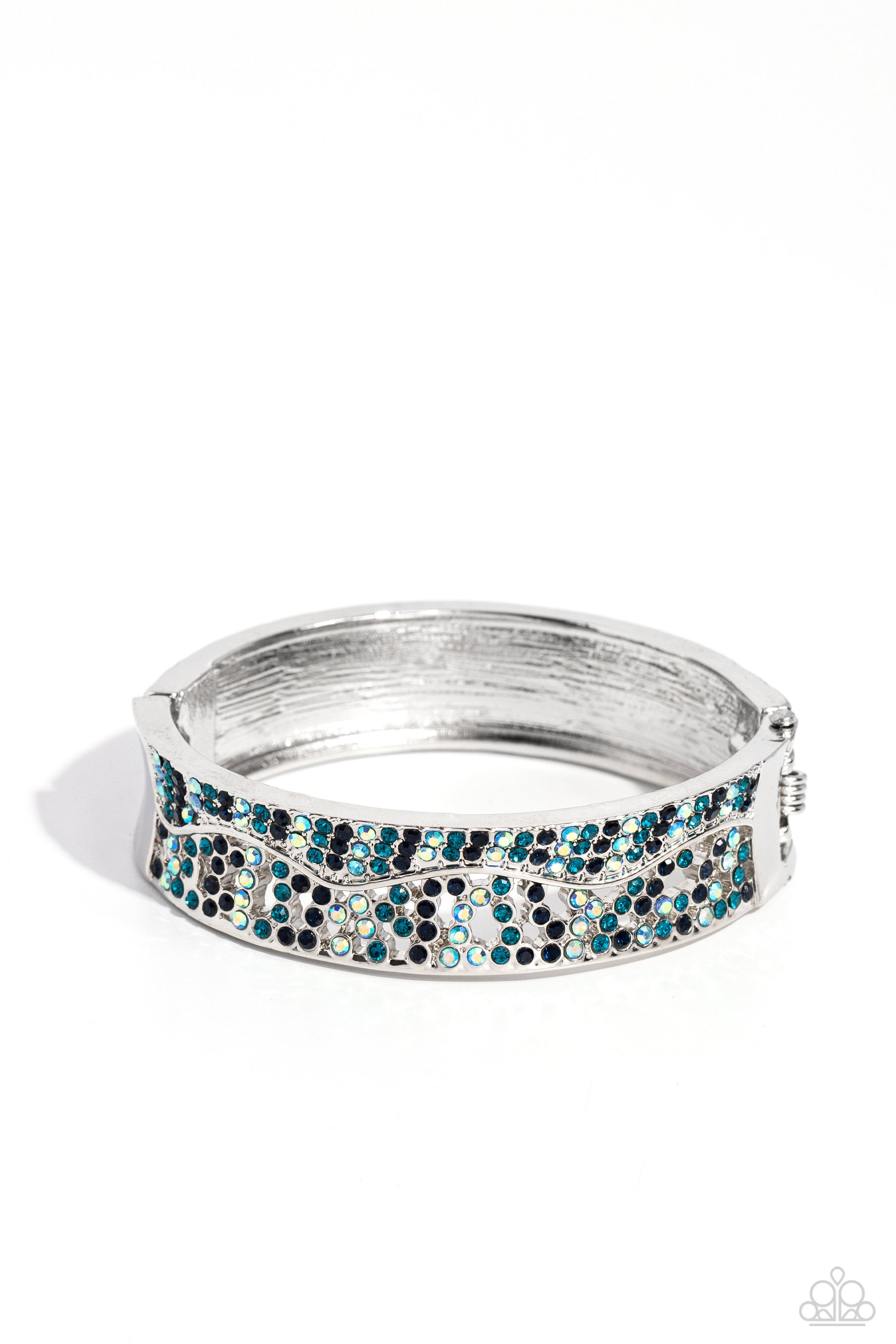 Wavy Whimsy Blue Hinge Bracelet - Paparazzi Accessories  Dusted in sections of dainty Montana, blue iridescent, and blue rhinestones, asymmetrically wavy thick silver bars boldly cross around the wrist in an airy pattern creating a gritty yet glamorous cuff.  Sold as one individual bracelet.  Sku:  P9RE-BLXX-243XX
