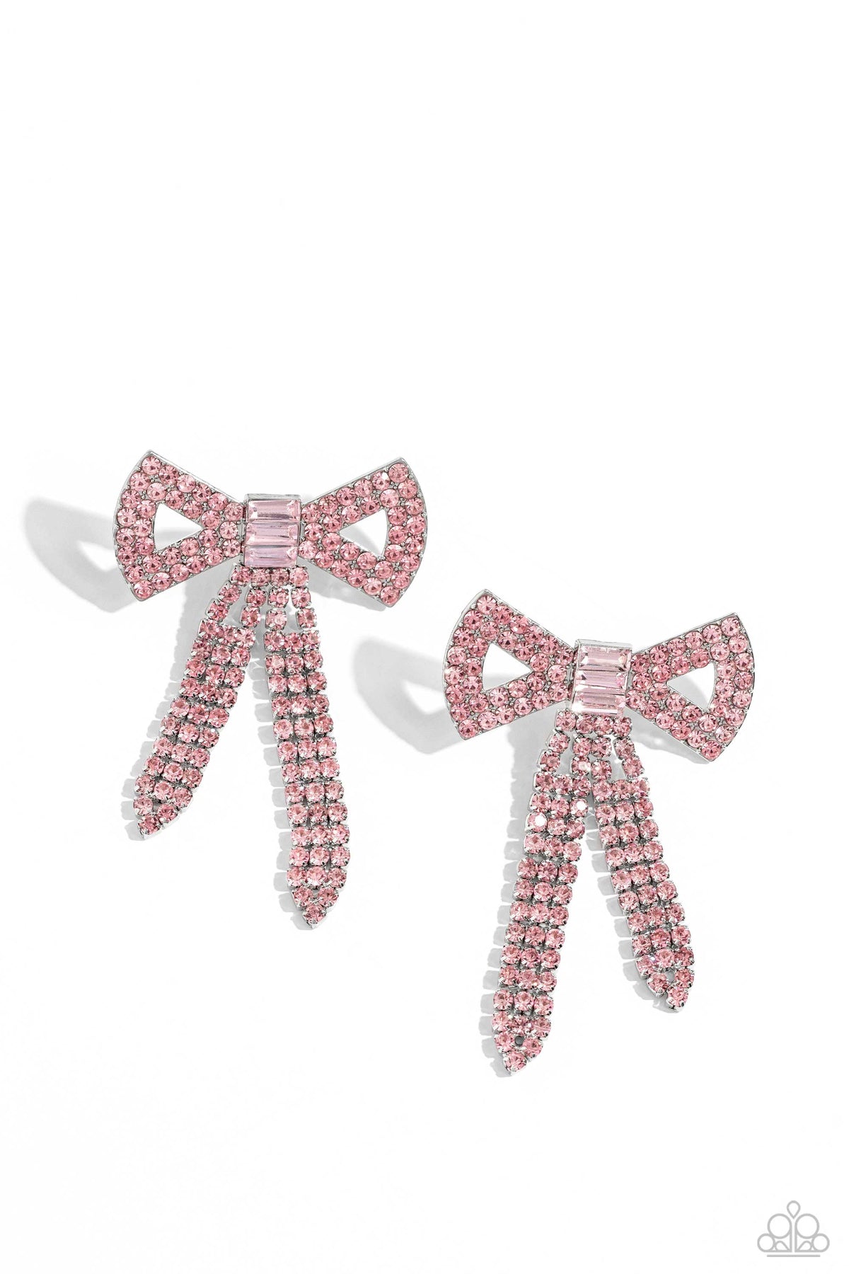 Just BOW With It Pink Post Earring - Paparazzi Accessories Featuring silver square fittings, high-sheen bands of silver, adorned in sparkling pink rhinestones loop into a stunning bow charm, creating a classy statement at the ear. Featured in the center of the classy design, a trio of emerald-cut pink gems tie the bow together emitting further sheen and glitz. Earring attaches to a standard post fitting. Sold as one pair of post earrings. P5PO-PKXX-091XX