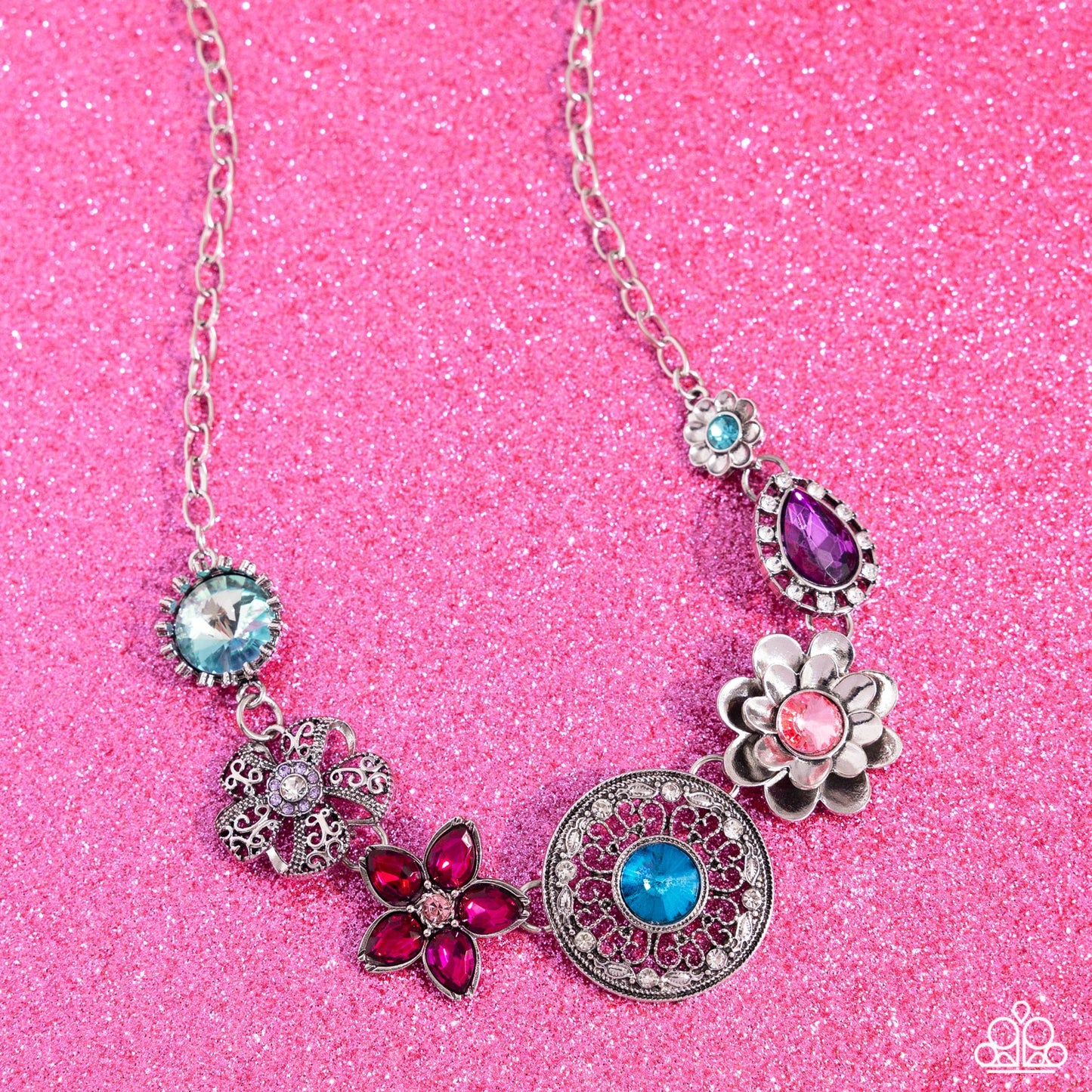 Giddy Garden Multi Flower Necklace (March 2024 LOP) - Paparazzi Accessories A variety of floral-inspired pendants featuring intricate detailing. Silver flowers featuring colorful gem centers and petals, followed by an airy filigree flower with a glistening rhinestone center. Two faceted round and teardrop gems are encircled by classic white rhinestones. Silver and white rhinestones radiate from a blue gem, creating the centermost pendant. Includes one pair of matching earrings. SKU: P2ST-MTXX-141XX