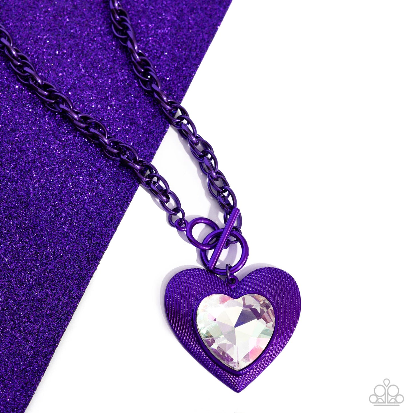 Modern Matchup Purple Heart Necklace (March 2024 LOP) - Paparazzi Accessories Bordered in linear textures, an oversized white heart gem is pressed into an electric purple heart frame below the collar. The flirtatious pendant attaches to a thick, electric purple chain, resulting in a modern-inspired romance. Features a lariat closure. Sold as one individual necklace. Includes one pair of matching earrings. SKU: P2ST-PRXX-166XX