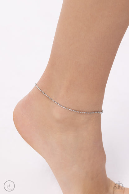 Blinding Basic White Rhinestone Anklet - Paparazzi Accessories  Set in silver square fittings, dainty white rhinestones cascade around the ankle creating a glittering, basic display. Features an adjustable clasp closure.  Sold as one individual anklet.  P9AN-WTXX-052XX