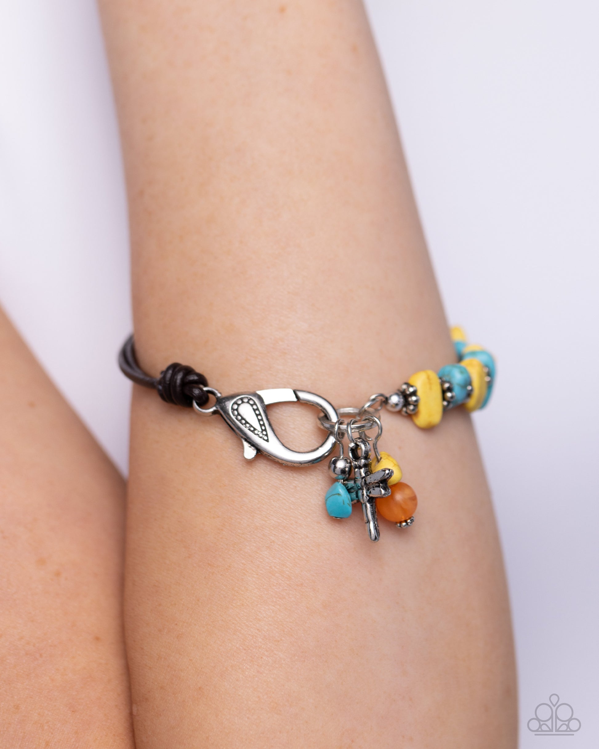Daring Dragonfly Yellow Clasp Bracelet - Paparazzi Accessories  Featuring a brown half-leather band, a collection of silver floral beads alternates between yellow and turquoise stones for an earthy display around the wrist. A silver dragonfly dances alongside a yellow and orange stone at the end of the hoop for additional whimsical charm. Features a clasp closure. As the stone elements in this piece are natural, some color variation is normal.  Sold as one individual bracelet.  P9SE-YWXX-174XX