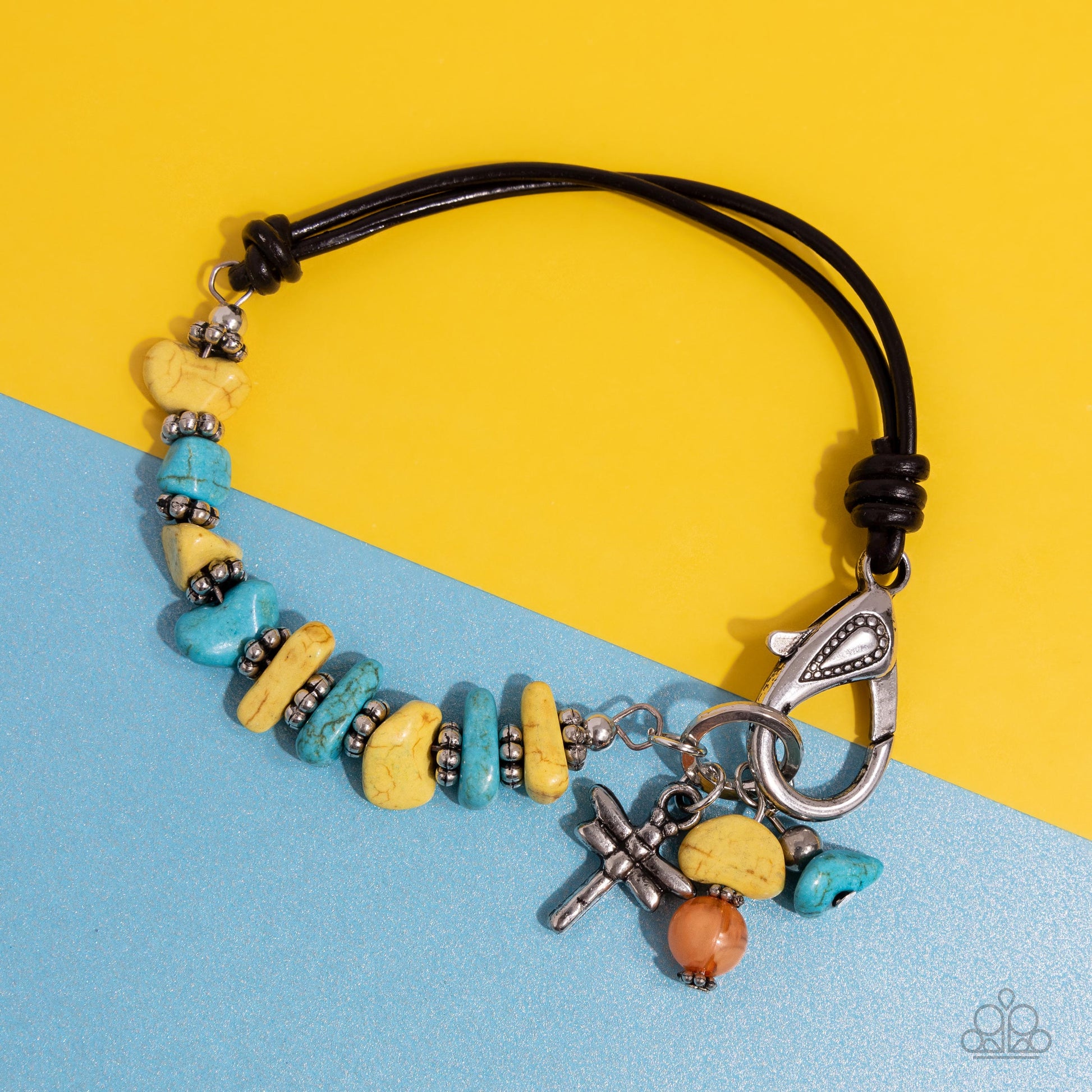 Daring Dragonfly Yellow Clasp Bracelet - Paparazzi Accessories  Featuring a brown half-leather band, a collection of silver floral beads alternates between yellow and turquoise stones for an earthy display around the wrist. A silver dragonfly dances alongside a yellow and orange stone at the end of the hoop for additional whimsical charm. Features a clasp closure. As the stone elements in this piece are natural, some color variation is normal.  Sold as one individual bracelet.  P9SE-YWXX-174XX