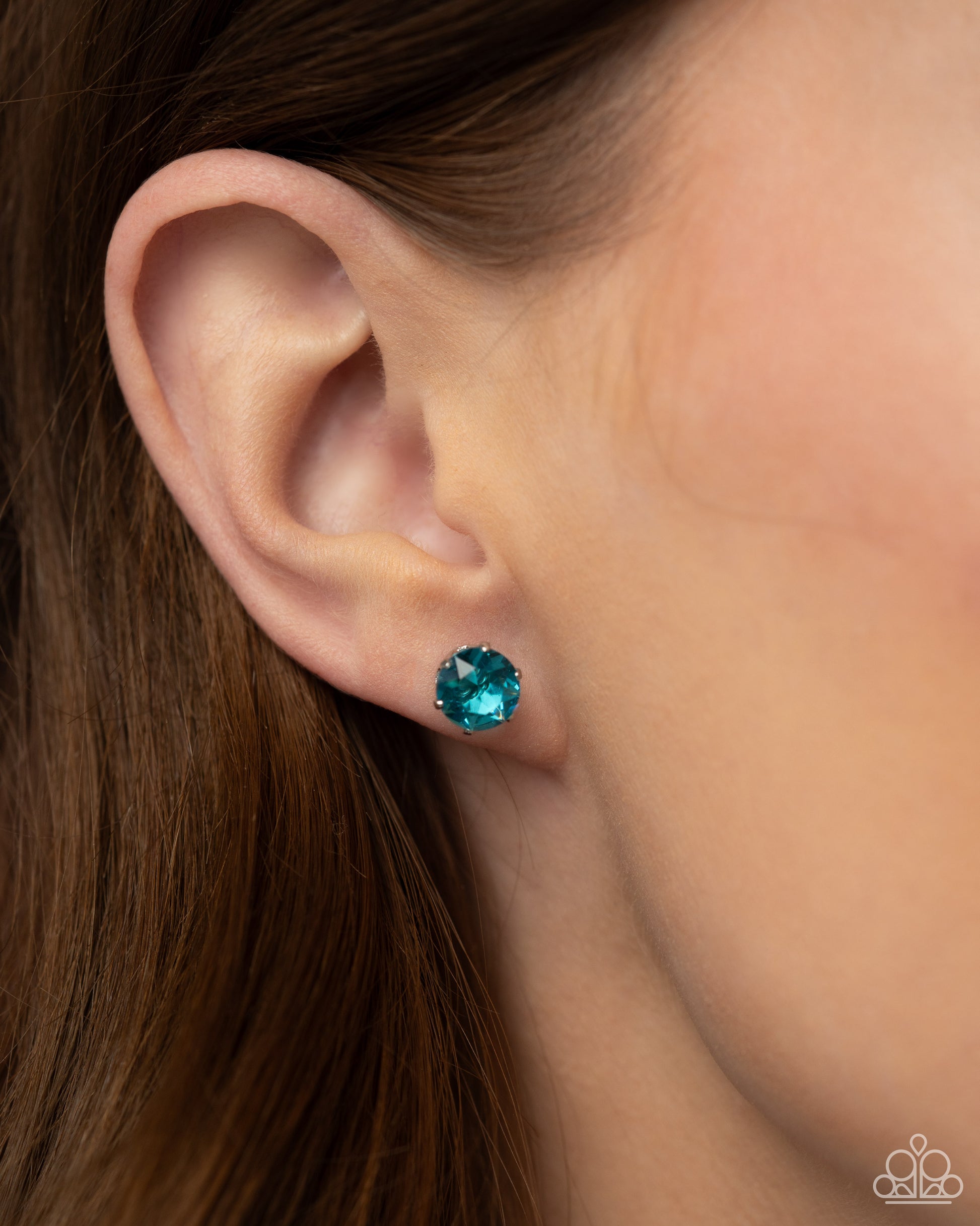 Breathtaking Birthstone Turquoise Rhinestone Post Earring - Paparazzi Accessories  A sparkling turquoise rhinestone is nestled inside a classic silver frame for a beautiful birthstone-inspired display. Earring attaches to a standard post fitting.  Sold as one pair of post earrings.  P5PO-BLXX-175UG