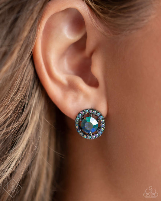 Dynamic Dominance - Blue Item #P5PO-BLXX-177UO   Featuring a UV shimmer, a glittery blue gem is pressed into an airy, gunmetal frame radiating with dainty blue UV rhinestones for a timeless, edgy flair. Earring attaches to a standard post fitting.  Sold as one pair of post earrings.