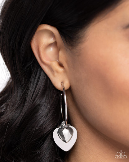 Casually Crushing Silver Heart Hoop Earring - Paparazzi Accessories  Featuring various textures, a trio of silver hearts in varying sizes cascades from a thin silver hoop for a romantic statement. Earring attaches to a standard post fitting. Hoop measures approximately 1 1/2" in diameter.  Sold as one pair of hoop earrings.  SKU: P5HO-SVXX-387XX