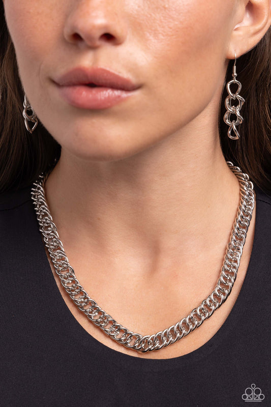 Industrial Ideology Silver Necklace - Paparazzi Accessories  High-sheen silver links connect below the collar into a bold, statement-making chain. Features an adjustable clasp closure.  Sold as one individual necklace. Includes one pair of matching earrings.  P2IN-SVXX-259XX