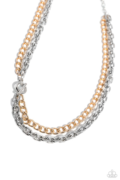 Industrial Improv Silver Necklace - Paparazzi Accessories A gritty collection of silver links boldly pairs with a classic gold chain below the collar, interlocking through a silver toggle clasp at the center of the design, resulting in an intense industrial look. Features an adjustable clasp closure. Sold as one individual necklace. Includes one pair of matching earrings. SKU: P2IN-SVXX-265XX