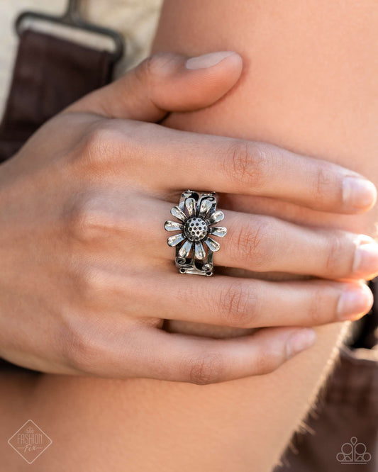 Landslide Lover - Silver Item #P4SE-SVXX-089VM   Featuring a dotted center, an airy silver sunflower blooms from the center of an airy band. Silver vine-like swirls curl from the ends of the flower for additional whimsical detail. Features a stretchy band for a flexible fit.  Sold as one individual ring.