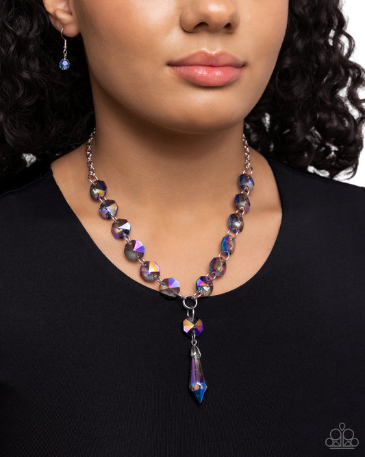Celestial Class Blue Necklace - Paparazzi Accessories  Featuring an opalescent, UV shimmer, faceted blue beads flicker and flash along a silver chain as it extends below the neckline, leading the eye to a faceted, prismatic bead for a finishing touch of shimmer. Features an adjustable clasp closure. Due to its prismatic palette, color may vary.  Sold as one individual necklace. Includes one pair of matching earrings.  P2ST-BLXX-272XX