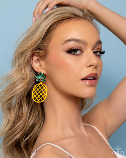 Pineapple Passion Yellow Post Earring - Paparazzi Accessories Pressed in gold frames, a collection of green elongated oval gems fan out around the ear from a trio of three dainty green rhinestones. The green bejeweled array gives way to a yellow airy frame, resembling an oversized pineapple for a fruity finish. Earring attaches to a standard post fitting. Sold as one pair of post earrings. SKU: P5PO-YWXX-040XX