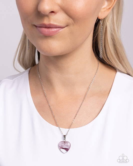 HEART Exhibition Purple Necklace - Paparazzi Accessories Featuring a swirl of purple detail, a clear acrylic heart pendant glides along a dainty silver chain cascading below the neckline for an adorably abstract statement. Features an adjustable clasp closure. Sold as one individual necklace. Includes one pair of matching earrings. SKU: P2DA-PRXX-156XX