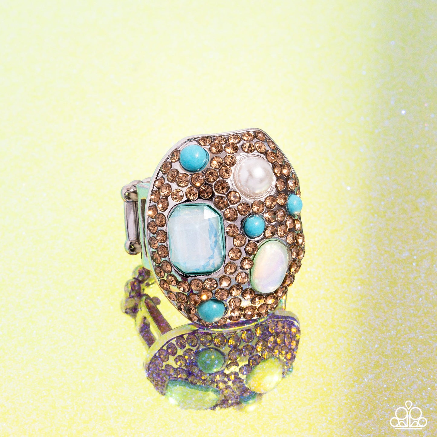 Active Artistry Blue Ring (May 2024 LOP) - Paparazzi Accessories  Item #P4ST-BLXX-030XX   Embellished in light-colored topaz rhinestones, an oval abstract silver ring glitters atop the finger. Turquoise beads, a white pearl, an emerald-cut aquamarine gem, and an aquamarine iridescent oval bead create additional color and shine. Features a stretchy band for a flexible fit. Due to its prismatic palette, color may vary.  Sold as one individual ring.