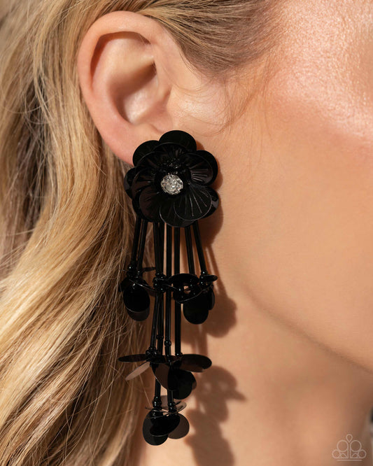 Floral Future Black Post Earring - Paparazzi Accessories Blooming from a faceted white gem center, textured black sequin petals give way to a collection of black cylindrical beaded strands that elongate the neck. Sporadically bursting amongst the strands, a collection of simple black sequins flicker and flash for additional eye-catching interest. Earring attaches to a standard post fitting. Sold as one pair of post earrings. P5PO-BKXX-239XX