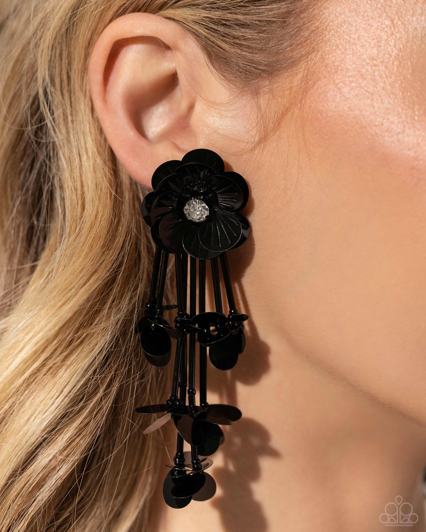 Floral Future Black Post Earring - Paparazzi Accessories Blooming from a faceted white gem center, textured black sequin petals give way to a collection of black cylindrical beaded strands that elongate the neck. Sporadically bursting amongst the strands, a collection of simple black sequins flicker and flash for additional eye-catching interest. Earring attaches to a standard post fitting. Sold as one pair of post earrings. P5PO-BKXX-239XX