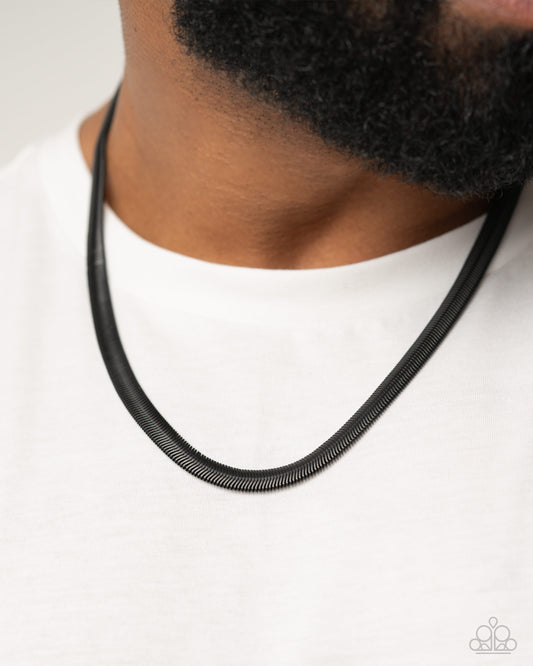Industrial Index Black Unisex Necklace - Paparazzi Accessories  Featuring a black-painted sheen, a dramatic herringbone chain loops below the collar for an industrial-inspired statement. Features an adjustable clasp closure.  Sold as one individual necklace.  P2MN-URBK-080XX
