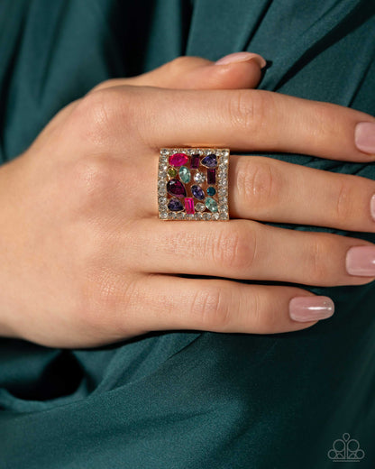 Framed Finesse Multi Ring - Paparazzi Accessories (June 2024 LOP)  Bordered in dainty white rhinestones, an exaggerated, airy gold square frame glistens atop the finger. Scattered through its airy middle, a collection of multicolored gems and rhinestones in various cuts completes the look with a dramatic flair. Features a stretchy band for a flexible fit.  Sold as one individual ring.  Item #P4RE-MTXX-059XX