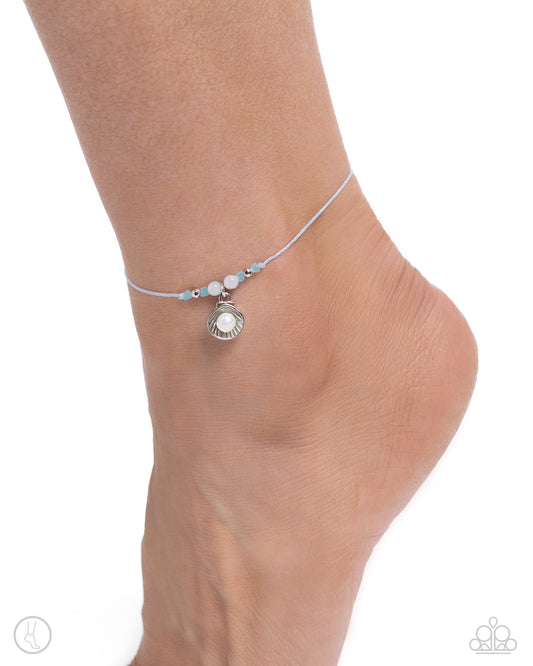Oyster Overture Blue Anklet - Paparazzi Accessories Centered along the knots of a light blue braided cord, a collection of textured silver and cloudy beads, and a pearl centered in a silver oyster shell wraps around the ankle for a beachy basic. Features an adjustable sliding knot closure. Sold as one individual anklet. P9AN-BLXX-049XX