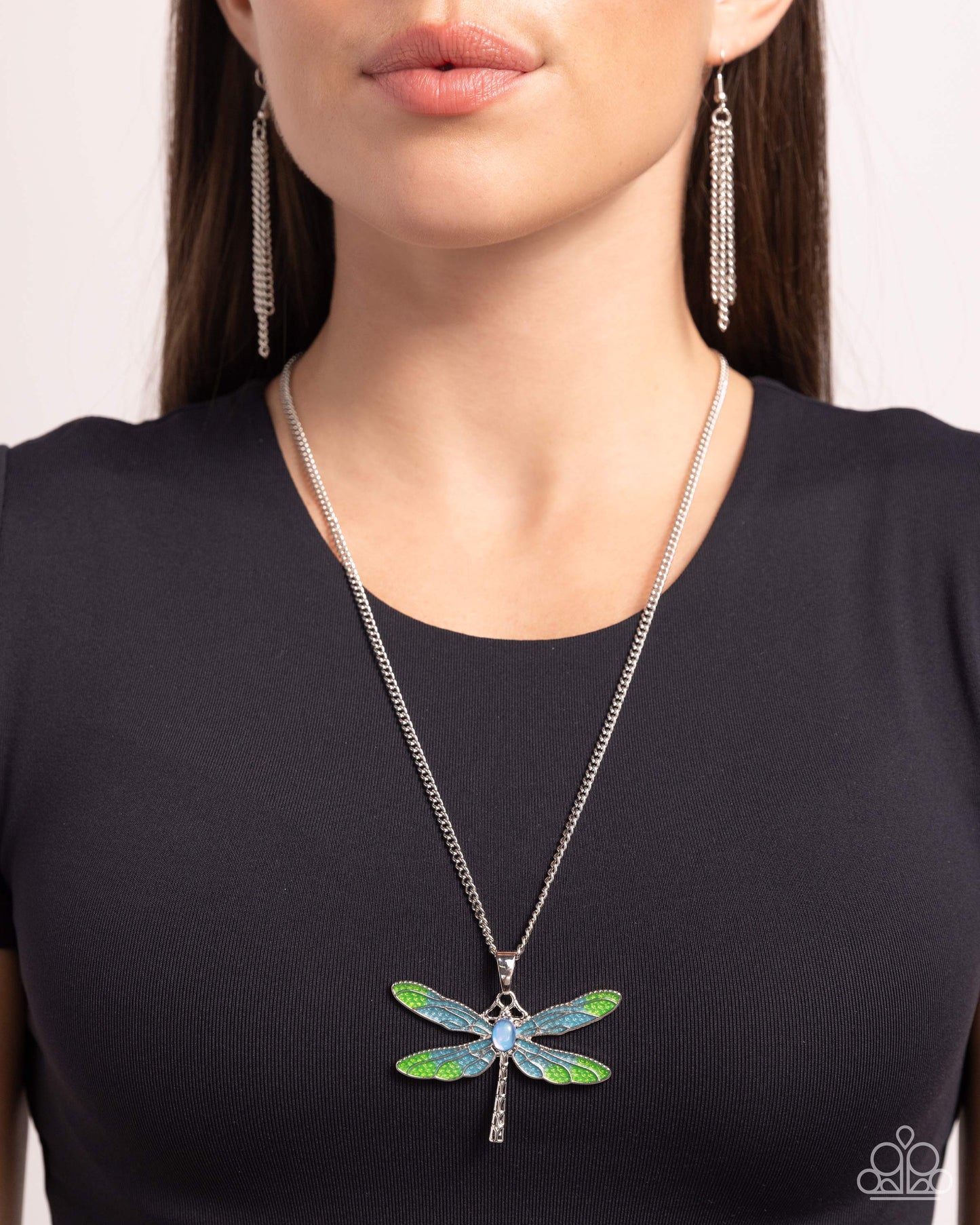 DRAGONFLY to the Sky Blue Necklace - Paparazzi Accessories Featuring a classic silver chain, a Capri Blue and light green painted silver dragonfly pendant glides along the neckline for a colorfully rustic centerpiece. An opalescent blue oval bead is pressed in the center of the display while textured silver connects and creates the rest of the dragonfly's body for additional eye-catching color and character. Features an adjustable clasp closure. Includes one pair of matching earrings. P2RE-BLXX-439XX