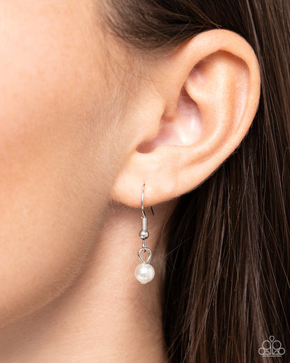 Filigree Infatuation White Pearl Heart Necklace - Paparazzi Accessories  A dainty collection of glossy white pearls gives way to an oversized filigree-filled silver heart frame, creating an antiqued locket-inspired look. Features an adjustable clasp closure.  Sold as one individual necklace. Includes one pair of matching earrings.  SKU: P2RE-WTXX-691XX