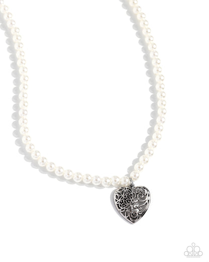 Filigree Infatuation White Pearl Heart Necklace - Paparazzi Accessories  A dainty collection of glossy white pearls gives way to an oversized filigree-filled silver heart frame, creating an antiqued locket-inspired look. Features an adjustable clasp closure.  Sold as one individual necklace. Includes one pair of matching earrings.  SKU: P2RE-WTXX-691XX