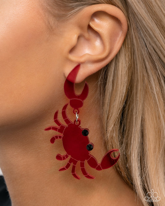 Crab Couture Red Post Earring - Paparazzi Accessories  Featuring faceted black gems, a glossy red acrylic crab cascades from its larger claw down the ear for a summery, beach-inspired look. Earring attaches to a standard post fitting.  Sold as one pair of post earrings.  SKU: P5PO-RDXX-063XX