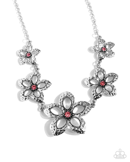 Faithful Florals Pink Necklace - Paparazzi Accessories  Delicately hammered in antiqued detail, airy silver flowers with silver studded detail and rose rhinestone centers gradually increase in size as they cascade around the neckline, creating a whimsically bold look. Features an adjustable clasp closure.  Sold as one individual necklace. Includes one pair of matching earrings.  P2ST-PKXX-178XX