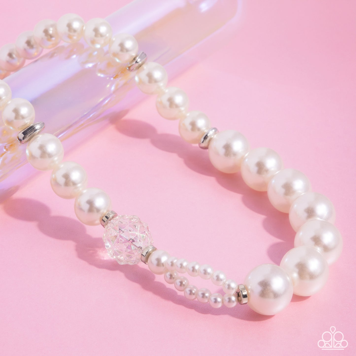 Crystal Class White Pearl Necklace - Paparazzi Accessories Infused along an invisible string, a collection of oversized glossy white pearls and silver rings that are interspersed throughout the design loop around the neckline. A crystal-like, multi-faceted bead and dainty double-stranded pearls attach to one side of the design for additional interest and appeal. Features an adjustable clasp closure. Sold as one individual necklace. Includes one pair of matching earrings. P2ST-WTXX-157XX