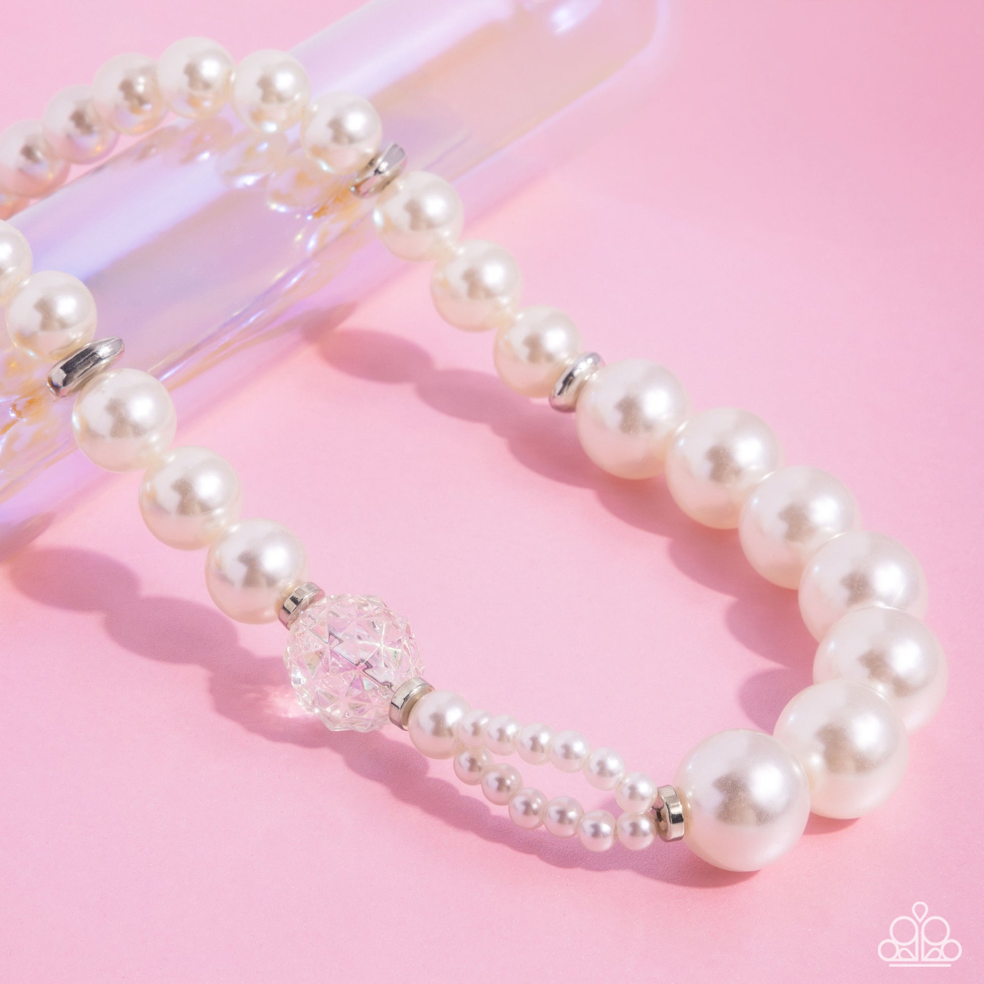 Crystal Class White Pearl Necklace - Paparazzi Accessories Infused along an invisible string, a collection of oversized glossy white pearls and silver rings that are interspersed throughout the design loop around the neckline. A crystal-like, multi-faceted bead and dainty double-stranded pearls attach to one side of the design for additional interest and appeal. Features an adjustable clasp closure. Sold as one individual necklace. Includes one pair of matching earrings. P2ST-WTXX-157XX